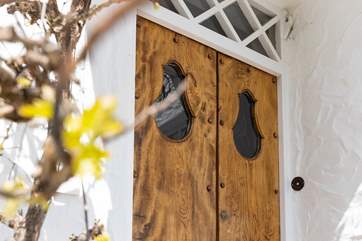 The front door of The Old Kiln is accessed via steps up from the main level of the garden.
