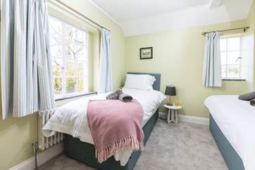 Bedroom three is a twin room with with a view of the estuary and the garden to the back of the house.