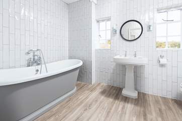 The main bathroom is large enough to accommodate both the roll-top bath, shower, WC and wash-basin.