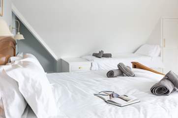 Bedroom one has a super king size bed and a single bed with an en suite shower room.