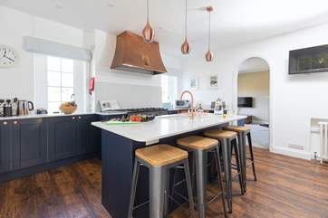 The modern kitchen with the original cooker hood. The snug leads off the kitchen.