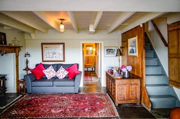 The sitting-room benefits from the old and the new whilst not forgetting the log stove for those chillier evenings.