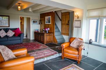 From the new into the old, the sitting-room offers a great space for the family to relax. Please note the step separating the two areas.