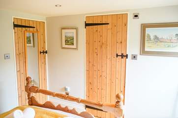 The mirrored door shuts on the optional additional single room, with the other door being the en suite.