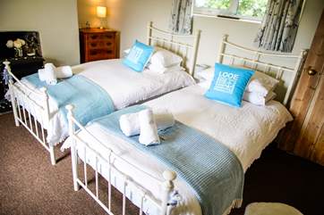 The twin room has an ornamental fireplace and benefits from dual-aspect windows allowing the room to flood with light.