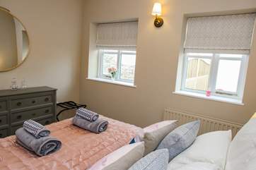 Bedroom 1 is a wonderful size and offers plenty of storage. This room looks out over the back courtyard area.