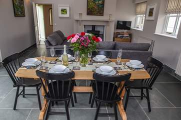 The dining-table sits centrally to the room and opposite the patio doors out on to the garden.