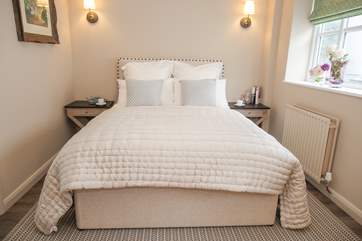 A bed dressed for the perfect night's sleep.