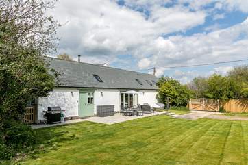 The gorgeous garden is enclosed and private due to its wooden gate.