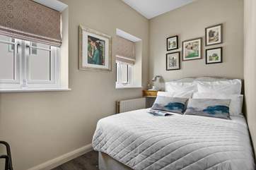 Bedroom 2 is decorated with some wonderful art.