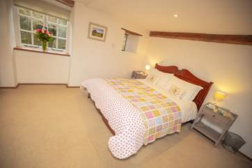The main bedroom is a wonderfully generous room offering a perfect place to recharge at the end of a day.