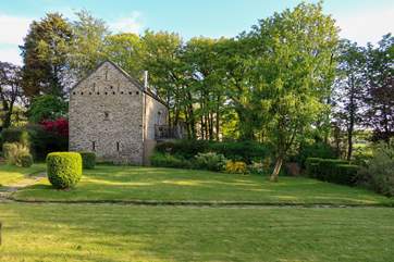 The barn is a wonderful reverse level property set in it's own grounds. This view is looking across from the owners lawned area.