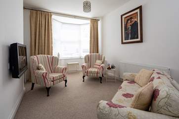 The sitting-room room is a cosy area to enjoy a touch of TV in the evening.