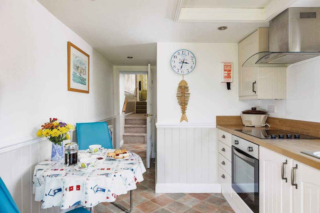 The kitchen leads up into the living room and bedroom.