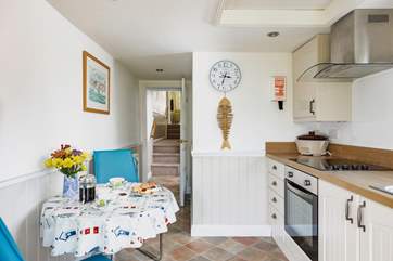 The kitchen leads up into the living room and bedroom.