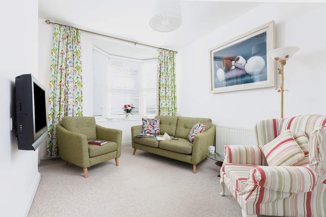 The sitting-room room is a cosy area to enjoy a touch of TV in the evening.