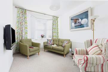 The sitting-room room is a cosy area to enjoy a touch of TV in the evening.