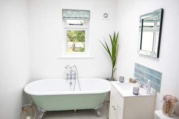The bathroom offers both a roll-top bath and a shower cubicle with the luxury of under-floor heating.