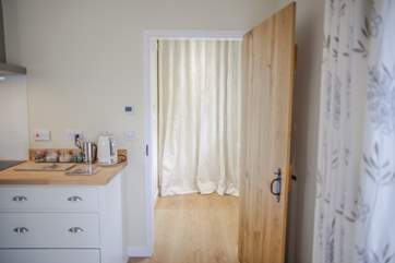 The bathroom is accessed via a hall to the left of the curtained door.
Please note the curtain soundproofs a door that links through to the owners' office area. This is fully locked and will not impact on your stay.