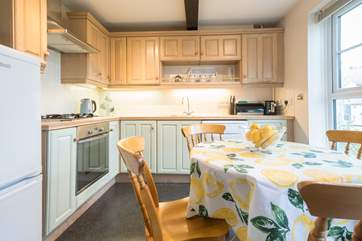 The kitchen area provides views across the pretty communal green area.