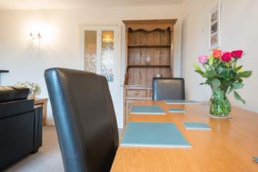 As well as a breakfast table in the kitchen, there is a dining table in the sitting/dining-room.