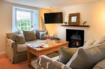 The cosy sitting-room with its toasty wood-burner makes this a perfect retreat all year round.