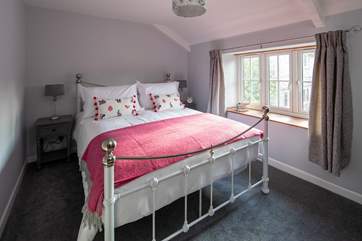 Delightful crisp white linen and super soft throws complete this bedroom.