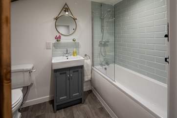 Fluffy white towels complete this family bathroom.