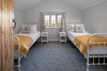 The twin bedroom has delightful views over the gardens.