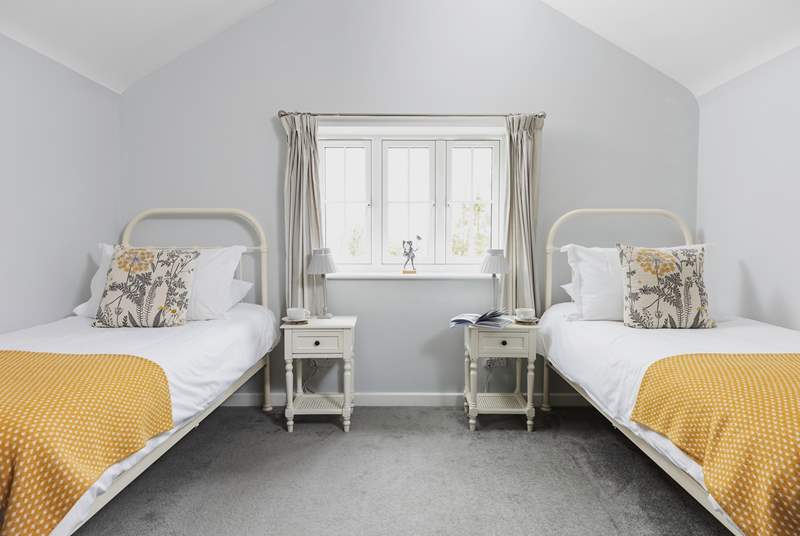 The twin bedroom has delightful views over the gardens.