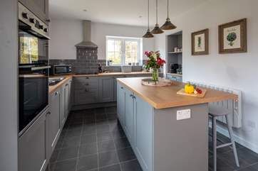 The gorgeous kitchen has a door out to your private patio.