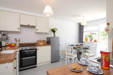 The sociable kitchen has stairs that lead out to the rear garden.