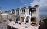 There is a sheltered rear terrace with stairs that lead into the kitchen. - Thumbnail Image