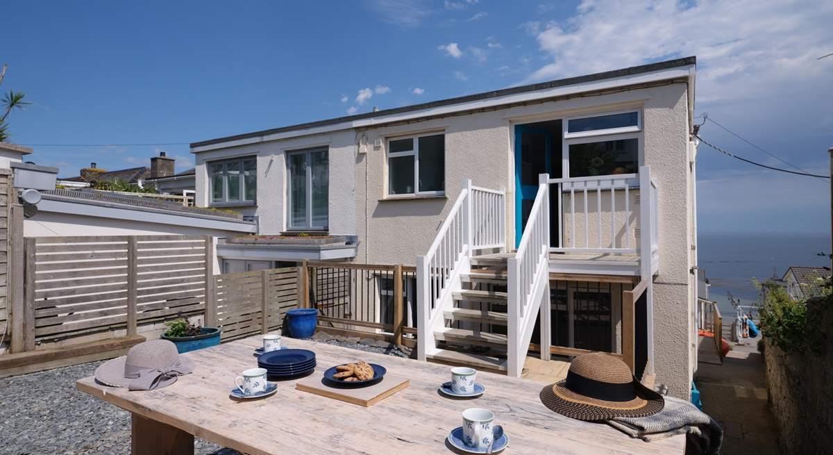 There is a sheltered rear terrace with stairs that lead into the kitchen.