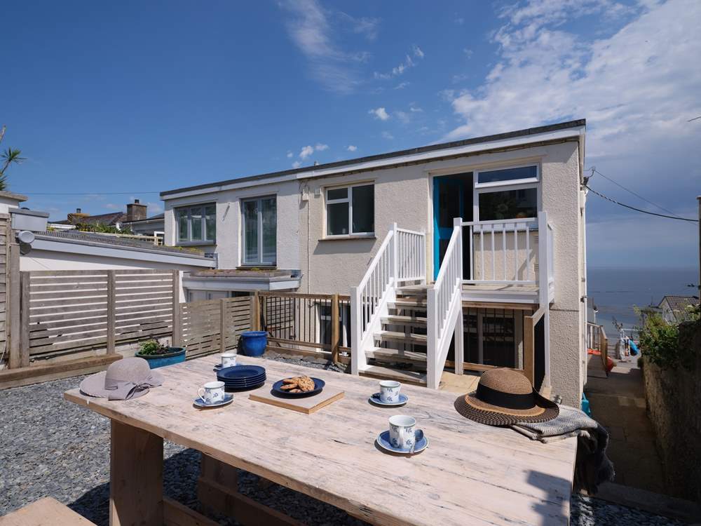 There is a sheltered rear terrace with stairs that lead into the kitchen.