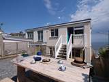 There is a sheltered rear terrace with stairs that lead into the kitchen.