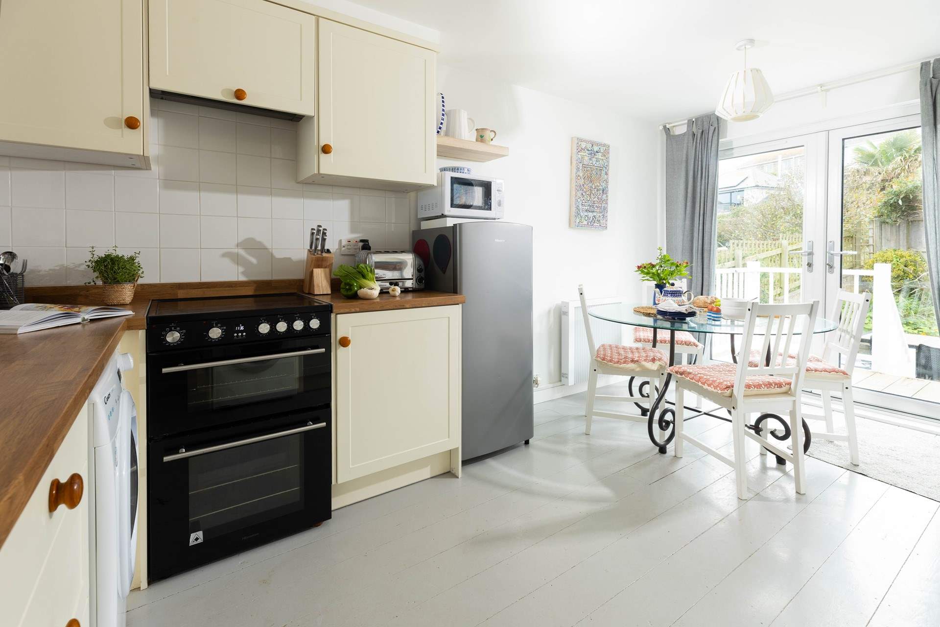 The sociable kitchen has stairs that lead out to the rear garden.