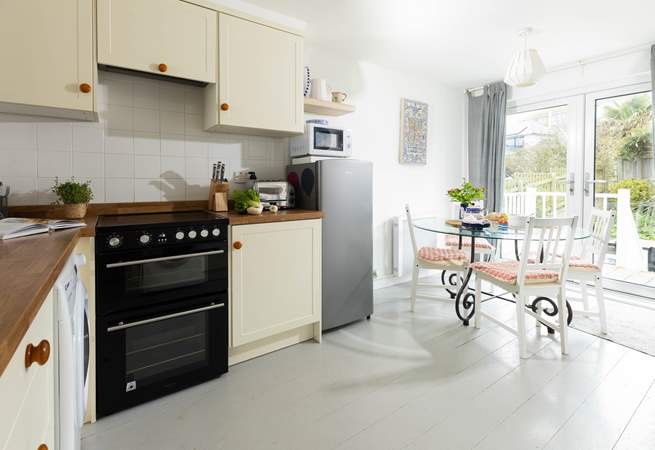 The sociable kitchen has stairs that lead out to the rear garden.