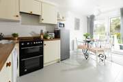The sociable kitchen has stairs that lead out to the rear garden.