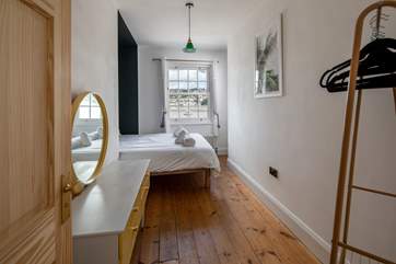 Bedroom three is home to a king-size bed and also offers waterside views.