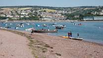 Shaldon beach, bustling with water activity.
