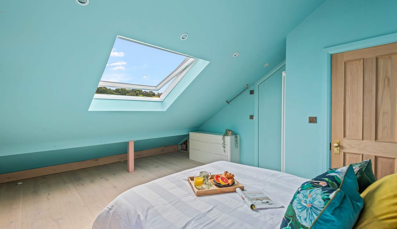 Light and airy bedroom 5 boasts views over Teignmouth back beach and the delightful array of beach huts.