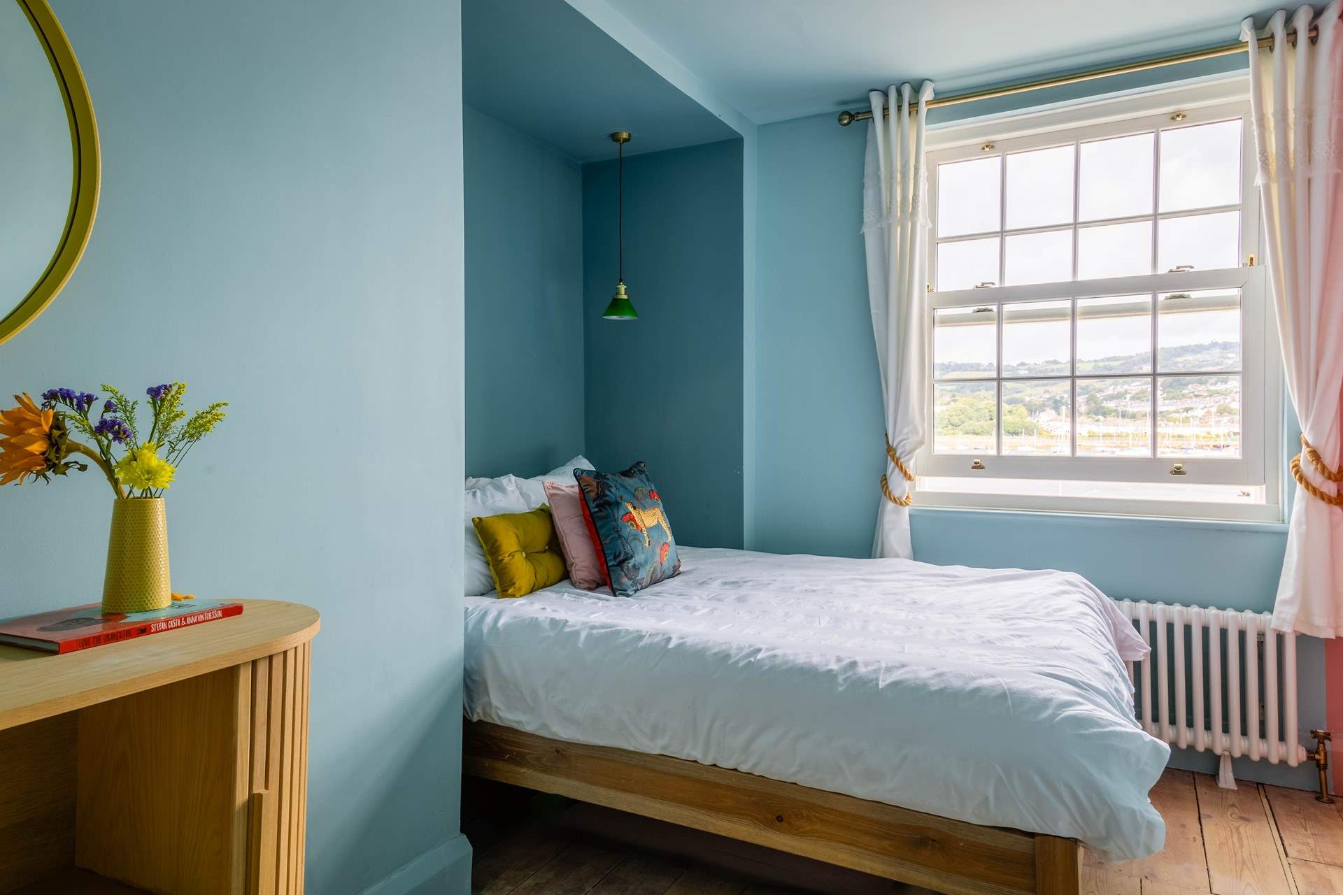Bedroom 3 is home to a king-size bed and also offers waterside views.