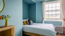 Bedroom 3 is home to a king-size bed and also offers waterside views.