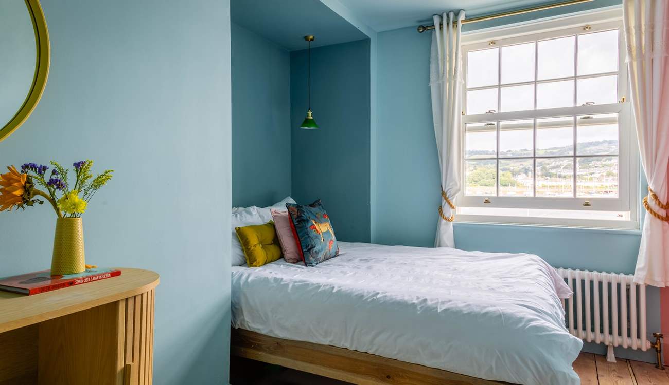 Bedroom 3 is home to a king-size bed and also offers waterside views.