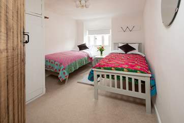 Colourful, soft linens await you in the twin bedroom.