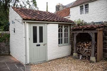 This sweet outhouse is a handy space to leave wellies and coats.