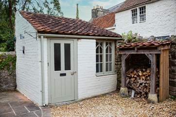 This sweet outhouse is a handy space to leave wellies and coats.