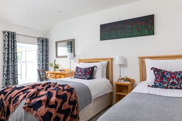 The twin bedroom also features crisp white linens and comfy beds.