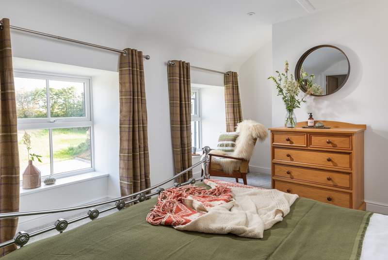 This dual-aspect bedroom has views over the garden.